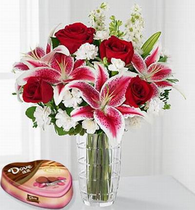 4 red Roses, 4 pink Lilies, white blossom fillers and a box of Chocolates.