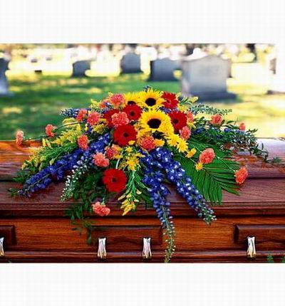 Arrangement of Daisies, Sunflowers, Carnations and an assorted mix of greenery.