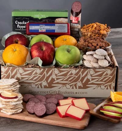 Delectable fruits - fresh from the farmer's market - are packed same day with snack mix, cookies, cheese, and crackers, to make your new favorite gift basket! This delicious assortment is sure to amaze. It's also perfectly balanced to suit all tastes.

Includes:
* Fresh Fruits - Apples & Oranges - 6 ct.
* Key Lime Cookies - 2.25 oz.
* Classic Vermont Sharp Cheddar Cheese - 8 oz.
* Sea Salt & Cracked Peppercorn Water Crackers - 4 oz.
* Chichester Crunch Snack Mix - 5 oz.
* Butter Toffee Peanuts - 5 oz.
* Summer Sausage - 5 oz.