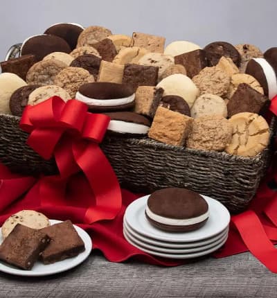 This ultimate basket of baked goods is perfect to please everyone in sight! Scrumptious whoopie pies, sweet and savory cookies, and decadent fudgy brownies in a variety of flavors are the perfect pairing for a momentous occasion.

Includes:
* Fudge Walnut Brownie
* 2 Chocolate Chunk Brownies
* 2 Peanut Butter Brownies
* 2 Chocolate Chip Blondies
* Butterscotch Blondie
* 2 White Chocolate Chip Macadamia Blondies
* 2 Oatmeal Raisin Cookies
* 2 Peanut Butter Cookies
* 2 Chocolate Chip Cookies
* 2 Fudge Brownie Cookies
* 2 Lemon Sugar Cookies
* 2 Pecan Sandy Cookies
* 6 Whoopie Pies
* Keepsake Gift Basket