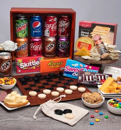 Bring family game night right to your home with this perfect gift set that has it all! With a delicious assortment of sweet and savory snacks as well as soda and candy, there's something here for everyone. Relax and enjoy a game of checkers with your loved ones, and then pack it all up in the convenient gift crate when you're done!

Includes:
* Checkers - 1 Game (board, pieces & satchel)
* Soda (Pop) - 8 cans
* Peanut Butter Chocolate Chip Cookies - 4.2 oz.
* (4) Theater Box Candies - 3.1 oz. each
* Stoned Wheat Crackers - 4 oz.
* (2) Cheddar Cheese - 2 oz.
* Smoked Gouda - 4 oz.
* Summer Sausage - 5 oz.
* Checker Board Crate