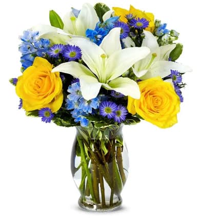 * White Asiatic Lilies
* Yellow Roses
* Blue Delphinium
* Purple Monte Casino
* Keepsake Glass Vase