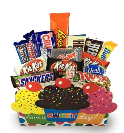 Send wishes to a chocolate lover in your life with this gift full of the most popular chocolate candy bars! They'll indulge in sweetness for their big day and have you to thank! This gift basket includes: This basket includes Almond Joy, Baby Ruth, Nestle Crunch, Peanut Butter Cups, Hershey Bars, Butterfingers, York Peppermint Patty, Kit Kat, Twix, Snickers & Chunky Bars.

Includes:
* Assortment of Chocolate Candy Bars
* Cupcake Container