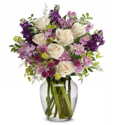 * Crme Roses
* Lavender Alstroemeria
* Purple Stock
* Purple Button Chrysanthemums
* Lavender Cushion Spray Chrysanthemums
* White Limonium
* Bupleurum
* Huckleberry
* Glass Vase