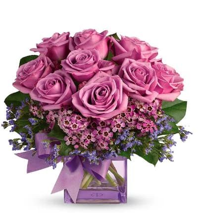 * Purple Roses
* Seasonal Greens
* Square Glass Vase
* Purple Ribbon