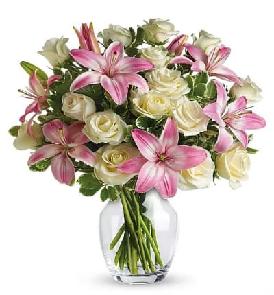 * One Dozen White Roses
* Pink Asiatic Lilies
* Variegated Pittosporum
* Glass Vase