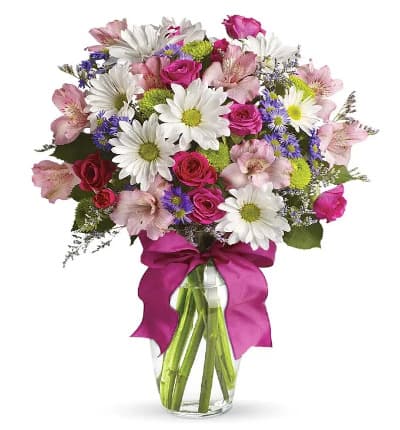 * Pink Spray Roses
* White Daisies
* Green Button Poms
* Purple Monte Casino
* Limonium
* Glass Vase
* Hot Pink Ribbon